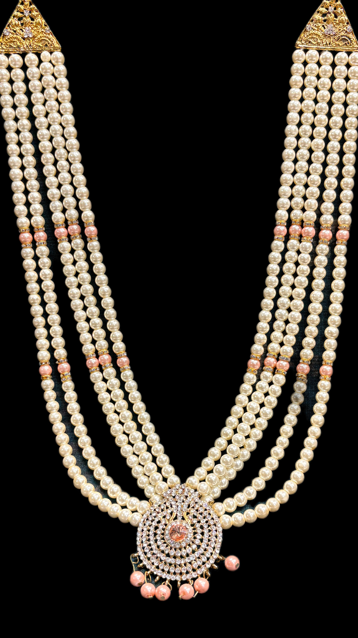 Multi-layer pearl necklace with peach accents and circular pendant design