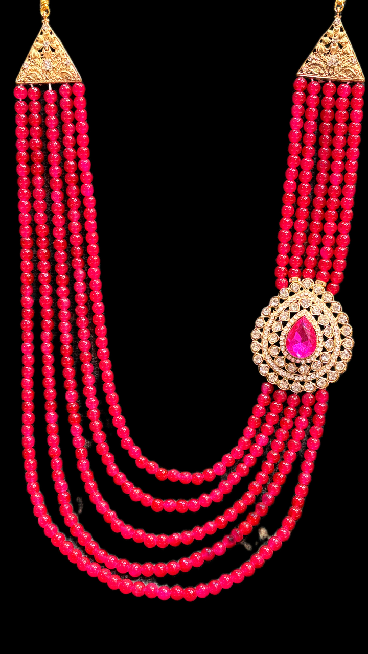 Red multi-layer beaded necklace with gold pendant and teardrop centerpiece